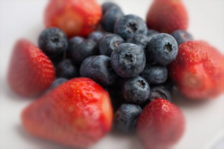 Fresh strawberries and blueberries on white backgroundの写真素材