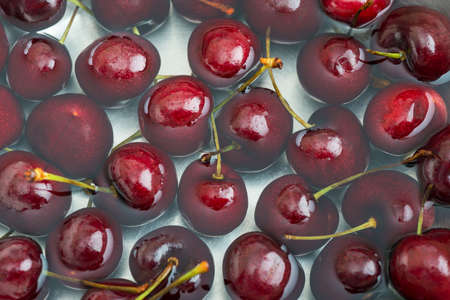 Red Cherries with Water on White Background