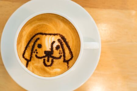 Top view latte art coffee on wood tableの写真素材