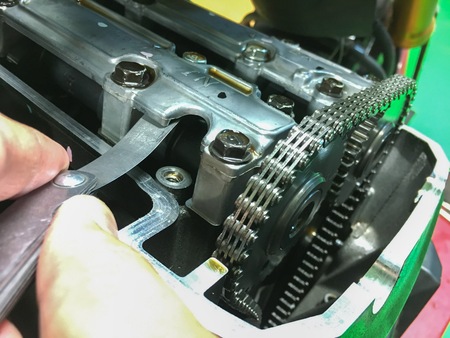 Adjust valve clearance by feeler gage