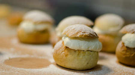 The traditional shrovetide bun - semla on a cutting board with dusted sugar.の写真素材