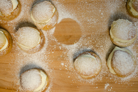 The traditional shrovetide bun - semla on a cutting board with dusted sugar.の写真素材