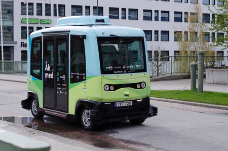 Stockholm, Sweden - 4 may 2018. A Self-driving bus on the straight street between Scandic Victoria hotel and the mall Kista Galleria in the northern Stockholm. Rolling the street for a trial period of 6 months.のeditorial素材