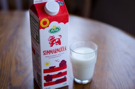 Stockholm, Sweden - 12 may 2018. A carton of milk and a glass of Arlas new milkのeditorial素材