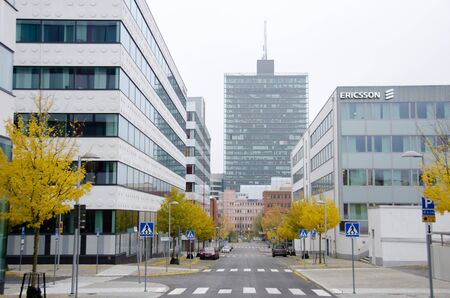 Stockholm, Sweden - 5 november 2017. Fall has arrived with the leaves of the trees changing colors at Ericsson famous landmark office in Kista with Kista science tower in the background.のeditorial素材