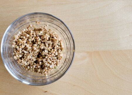 Buckwheat in a glass on a wooden tableの写真素材