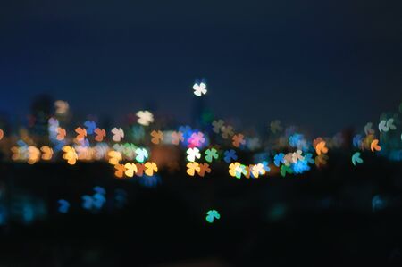 Bokeh Night City Light Landscape Background In Small Colorful Four Leaves Clover Shape Glowing Lightsの写真素材