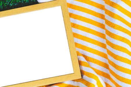 White Board In Wooden Frame For Quote With Yellow Stripe Tote Bag On Green Grass Backgroundの写真素材