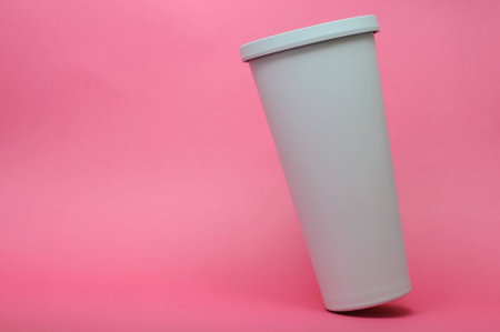 White Cold Saving Cup For Coffee And Tea On Pastel Pink Backgroundの写真素材