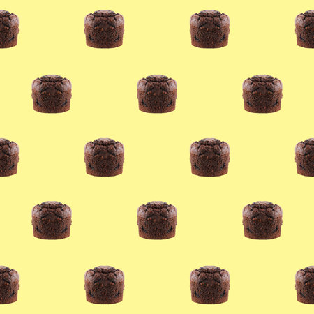 Seamless Pattern Of Chocolate Muffins On Pastel Yellow Backgroundの写真素材