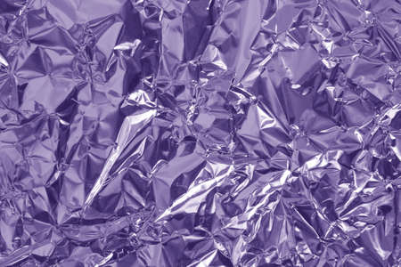 Shiny blue foil texture background, pattern of yellow wrapping paper with crumpled and wavy.の写真素材