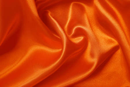 Orange fabric texture background, detail of silk or linen pattern.の写真素材