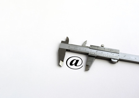 E-mail icon vith metal vernier on the white backgroundの写真素材