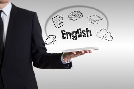 Learn English concept with young man holding a tablet computerの写真素材