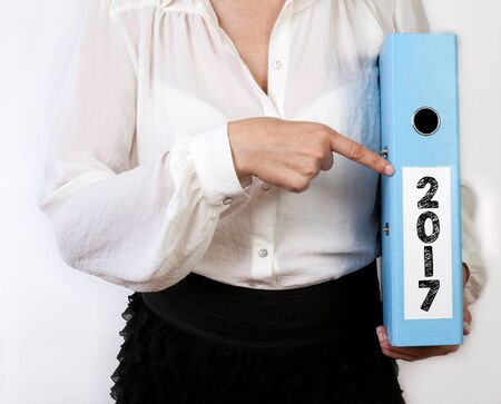 2017. Business women holding binder on white background.