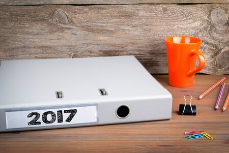 2017, folder on wooden office desk, texture background