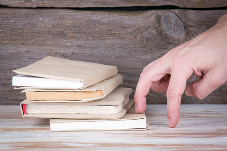 Stack of books on a wooden table.の写真素材