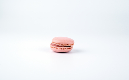 Pink tasty macaroon on white background, sweet and colorful dessert.の写真素材