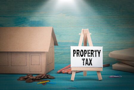 Property Tax. home model, money and a notice board under the sunlit.の写真素材