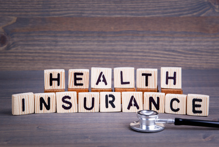 Health insurance from wooden letters. Abstract business and success background.の写真素材