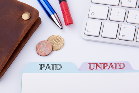 Paid and Unpaid. Folder Register on a white Office Table.の写真素材