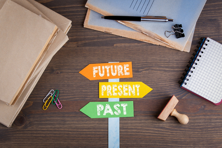 Future concept. Paper signpost on a wooden desk.の写真素材
