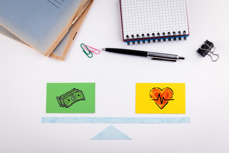 Work Life Balance concept. Paper scale on a white table.の写真素材