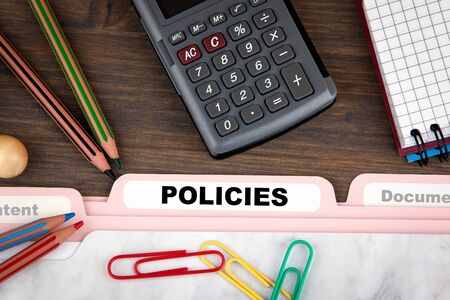Policies concept. Folder Register on a dark wooden desk.の写真素材