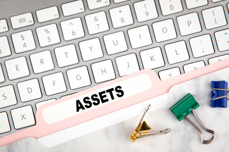 assets concept. Folder Register on a white computer keyboard.の写真素材