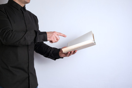 Free space for text, marketing education and business information. Man with a book on white...