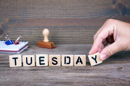 Tuesday. Wooden letters on the office desk, informative and communication background.の写真素材