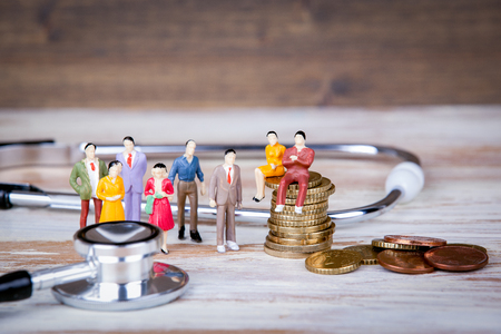 Medical care and expenses, health insurance. Colorful Human miniatures.の写真素材
