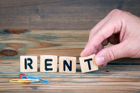 Rent. Wooden letters on the office desk. Business and money investment background.の写真素材