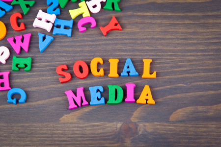 SOCIAL MEDIA various colored wooden letters on a dark plate.の写真素材