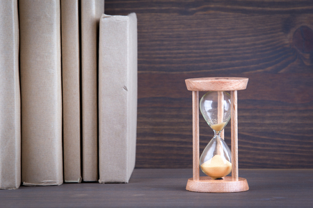 Sandglass, hourglass or egg timer on wooden table showing the last second or last minute or time out.の写真素材