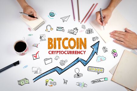 Bitcoin Cryptocurrency Concept. The meeting at the white office table.の写真素材