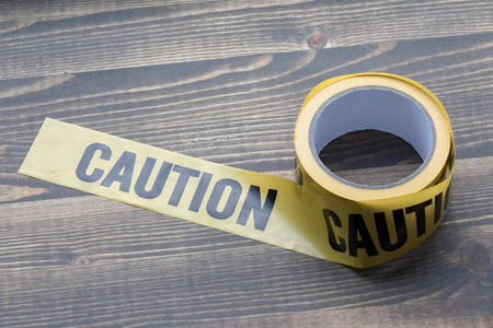 yellow caution tape on a wooden background. Safety Barrier For Police Barricade, For Contractors.