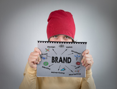 brand concept. man holding gray notebook, marketing and information.の写真素材