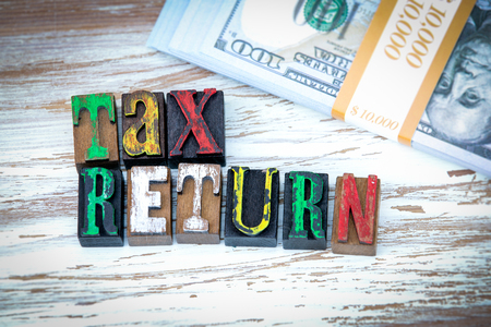 Tax Return. Wooden letters on the office desk, informative and communication backgroundの写真素材