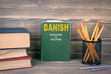 Danish language and culture concept. Book on a wooden backgroundの写真素材