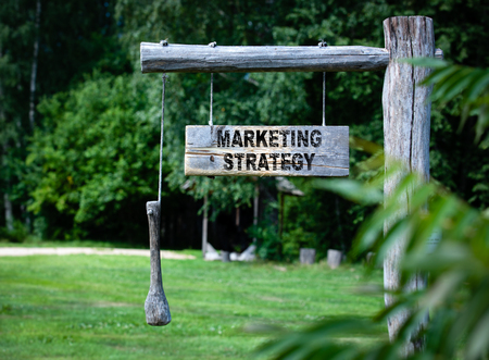 Marketing Strategy concept. inscription on a wooden announcment board outdoars at countrysideの写真素材