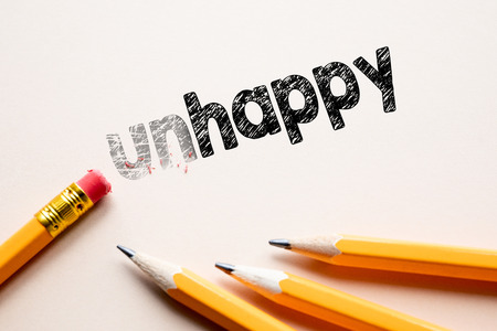 Making unhappy in to happy by eraser. Concept for action and reaching goalsの写真素材