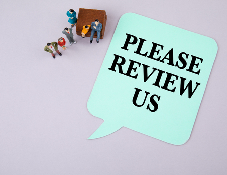 Please Review Us. Social media and business concept. Paper speech bubbleの写真素材