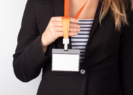 White empty staff identity mockup with orange lanyard. Woman wear blankの写真素材