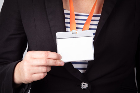 White empty staff identity mockup with orange lanyard. Woman wear blankの写真素材