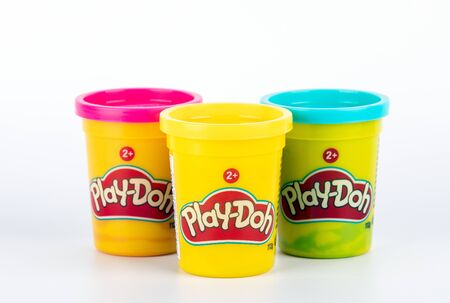 Riga, Latvia - November 05, 2018: Play-Doh clay in a yellow small container with Red, Yellow and Blue cover on white backgroundのeditorial素材