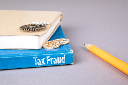 tax fraud concept. blue book on a gray office table. communication and informationの写真素材