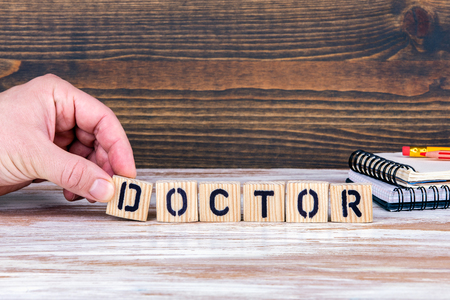 Doctor. Wooden letters on the office desk, informative and communication backgroundの写真素材