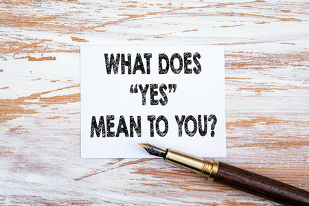 What does Yes mean to you. Paper letter and pen on a wooden tableの写真素材