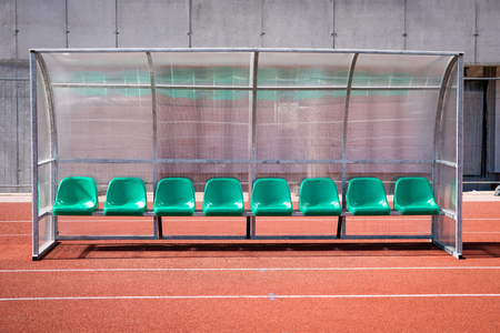 Coach and reserve benches in soccer stadium.の写真素材